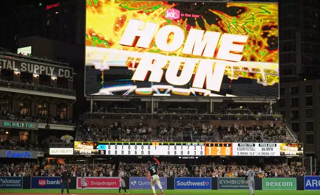 San Diego Padres' Jackson Merrill, center, celebrates after hitting a home run during the eighth inning of a baseball game against the Miami Marlins Friday, Sept. 18, 2026, in San Diego. (AP Photo/Gregory Bull)