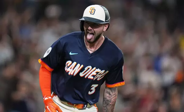 San Diego Padres' Jackson Merrill celebrates after hitting a home run during the eighth inning of a baseball game against the Miami Marlins Friday, Sept. 18, 2026, in San Diego. (AP Photo/Gregory Bull)