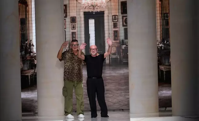 Stefano Gabbana and Domenico Dolce accept applause at the end of the Dolce & Gabbana women's Spring-Summer 2027 fashion show, presented in Milan, Italy, Saturday, Sept. 26, 2026. (AP Photo/Luca Bruno)