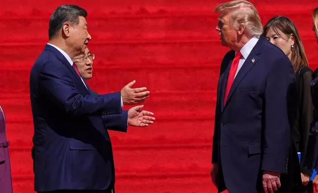 China's President Xi Jinping, left, speaks with President Donald Trump on the steps of the National Archives Museum, Friday, Sept. 25, 2026, in Washington. (AP Photo/Julia Demaree Nikhinson)