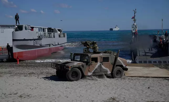 Greek service members drive a military vehicle ashore from a landing craft during Medusa 15, a multinational military exercise led by Greece and Egypt, in Maleme on the Greek island of Crete, Friday, Sept. 18, 2026. (AP Photo/Thanassis Stavrakis)