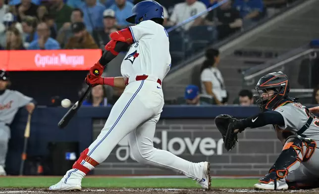 Toronto Blue Jays' Kazuma Okamoto (7) hits a single against the Detroit Tigers during the second inning of a baseball game in Toronto, Tuesday, Sept. 15, 2026. (Jon Blacker/The Canadian Press via AP)