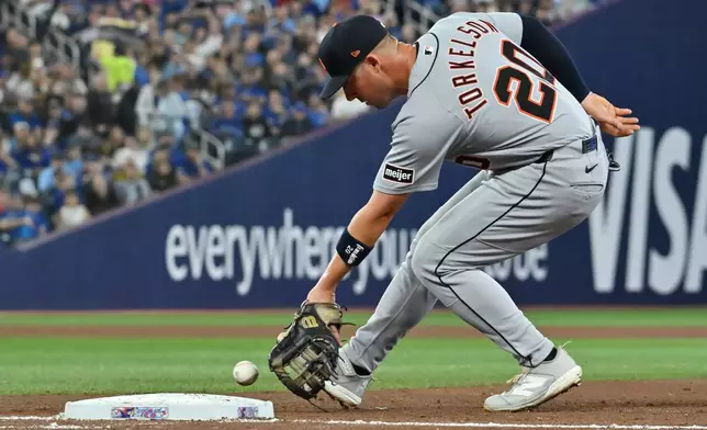 Detroit Tigers first baseman Spencer Torkelson (20) scoops up a ground ball off the bat of Toronto Blue Jays' Nathan Lukes for an out during fourth inning of a baseball game in Toronto, Tuesday, Sept. 15, 2026. (Jon Blacker/The Canadian Press via AP)