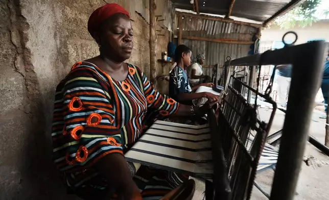 Chabi Baké, a mother of five, weaves in Parakou, northern Benin, Saturday, May 16, 2026. (AP Photo/Sunday Alamba)