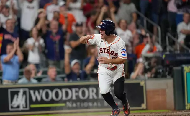 Houston Astros' Jose Altuve celebrates after scoring during the eighth inning of a baseball game against the Chicago White Sox Wednesday, Sept. 2, 2026, in Houston. (AP Photo/David J. Phillip)