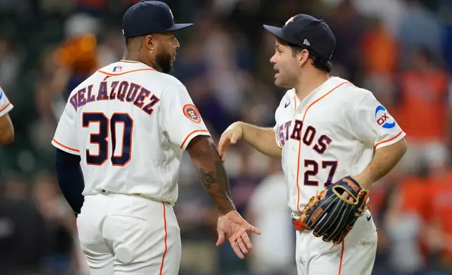 Houston Astros' Nelson Velázquez (30) and Jose Altuve (27) celebrate after a baseball game against the Chicago White Sox Wednesday, Sept. 2, 2026, in Houston. (AP Photo/David J. Phillip)