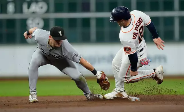 Houston Astros' Daulton Varsho steals second base as Chicago White Sox shortstop Colson Montgomery (12) reaches to tag him during the second inning of a baseball game Wednesday, Sept. 2, 2026, in Houston. (AP Photo/David J. Phillip)