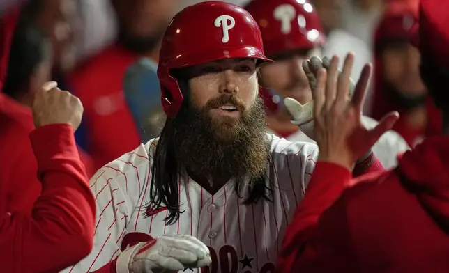 Philadelphia Phillies' Brandon Marsh celebrates his two-run home run off of Milwaukee Brewers pitcher Dustin May during the second inning of a baseball game, Tuesday, Sept. 22, 2026, in Philadelphia. (AP Photo/Matt Rourke)