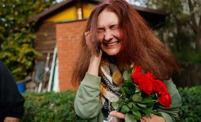 Tatsiana Kouzina, one of the released Belarusian prisoners, speaks on the phone as she arrives in Vilnius, Lithuania, Wednesday, Sept. 16, 2026. (AP Photo/Mindaugas Kulbis)