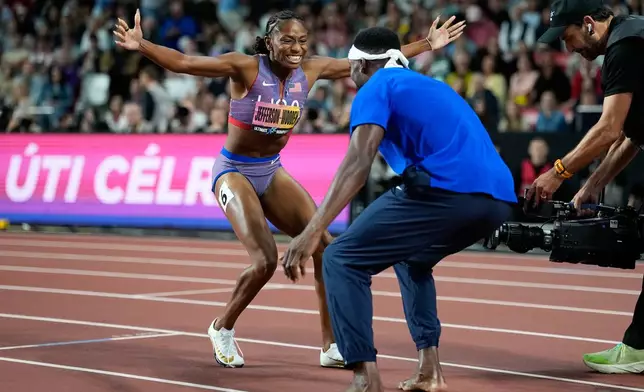 Melissa Jefferson-Wooden, of the United States, celebrates with sprinter Kenneth Bednarek, also of the United States, after winning the women's 200 meters final at the World Athletics Ultimate Championship in Budapest, Hungary, Sunday, Sept. 13, 2026. (AP Photo/Matthias Schrader)