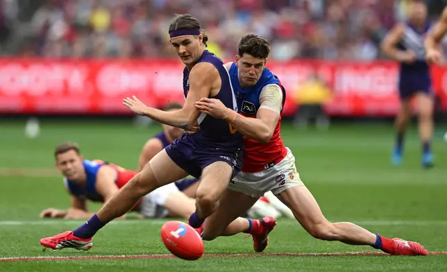 Murphy Reid of the Fremantle Dockers, left, is tackled by Jarrod Berry of the Brisbane Lions during the Australian Football League grand final in Melbourne, Australia Saturday, Sept. 26, 2026. (James Ross/AAP Image via AP)