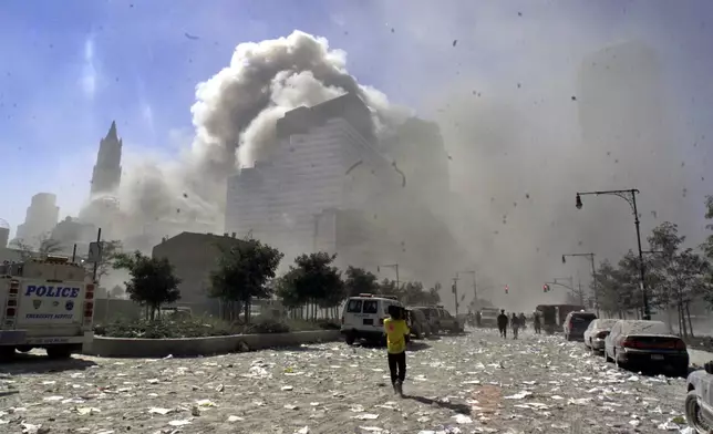 FILE - A street in New York's lower Manhattan area is littered with debris after the collapse of the twin towers of the World Trade Center following terrorist attacks, Sept. 11, 2001. (AP Photo/Richard Drew File,)