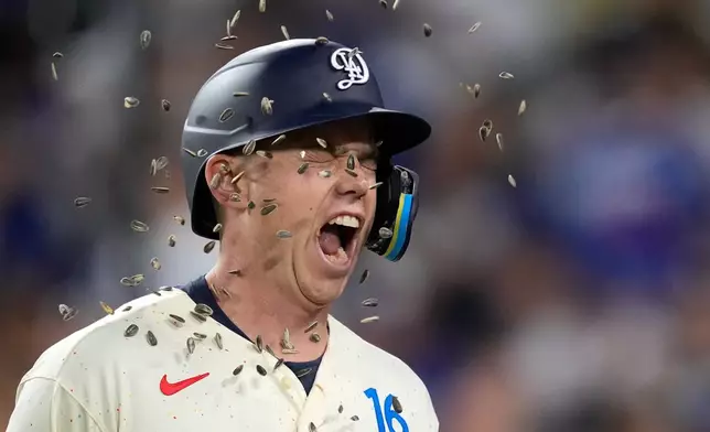 Los Angeles Dodgers' Will Smith has seeds thrown at him after hitting a solo home run during the third inning of a baseball game against the San Francisco Giants, Saturday, Sept. 19, 2026, in Los Angeles. (AP Photo/Mark J. Terrill)