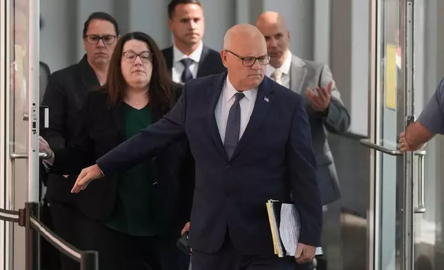 District Attorney for Plymouth County Timothy Cruz, front, leaves court after the judge declared a mistrial in Lindsay Clancy's murder trial at Plymouth County Superior Court, Friday, Sept. 4, 2026, in Plymouth, Mass. (AP Photo/Charles Krupa)