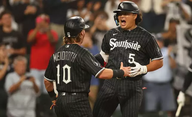 Chicago White Sox's Munetaka Murakami, right, celebrates his three-run with teammate Chase Meidroth, left, during the first inning of a baseball game against the Detroit Tigers, Thursday, Sept. 17, 2026, in Chicago. (AP Photo/Melissa Tamez)