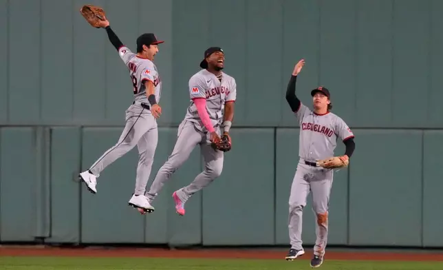 Cleveland Guardians Steven Kwan, Angel Martinez and Chase DeLauter, from left, celebrate after clinching a post season playoff spot following a baseball game against the Boston Red Sox, Thursday, Sept. 24, 2026, in Boston. (AP Photo/Charles Krupa)