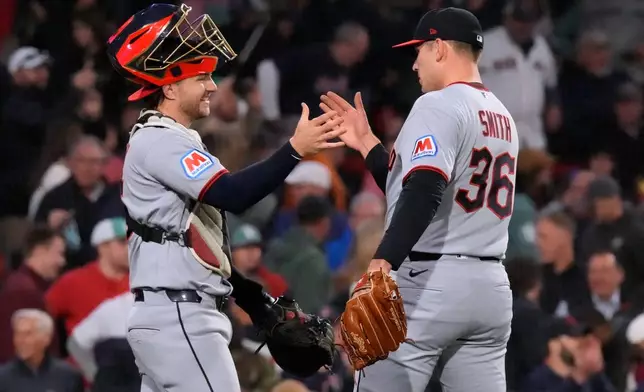 Cleveland Guardians' Cade Smith (36) is congratulated by Patrick Bailey after clinching a post season playoff spot following a baseball game against the Boston Red Sox, Thursday, Sept. 24, 2026, in Boston. (AP Photo/Charles Krupa)