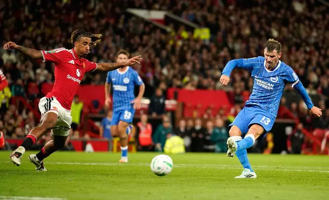 Brighton's Pascal Gross, right, scores his side's second goal during the English League Cup third round soccer match between Manchester United and Brighton and Hove Albion in Manchester, England, Wednesday, Sept. 16, 2026. (AP Photo/Dave Thompson)