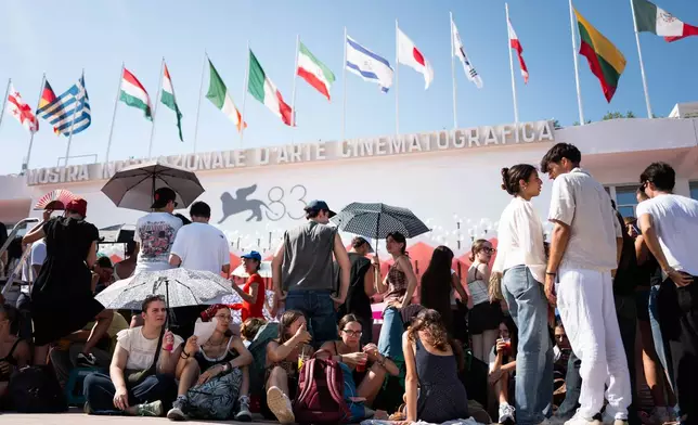 Festival goers gather before the 'Oasis: Don't Look Back in Anger' red carpet during the 83rd edition of the Venice Film Festival in Venice, Italy, on Saturday, Sept. 5, 2026. (Photo by Scott A Garfitt/Invision/AP)