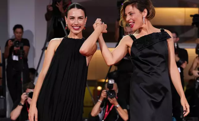 Romana Maggiora Vergano, left, and Jasmine Trinca pose for photographers at the red carpet for the film 'L'Estranea' during the 83rd edition of the Venice Film Festival in Venice, Italy, on Monday, Sept. 7, 2026. (Photo by Scott A Garfitt/Invision/AP)