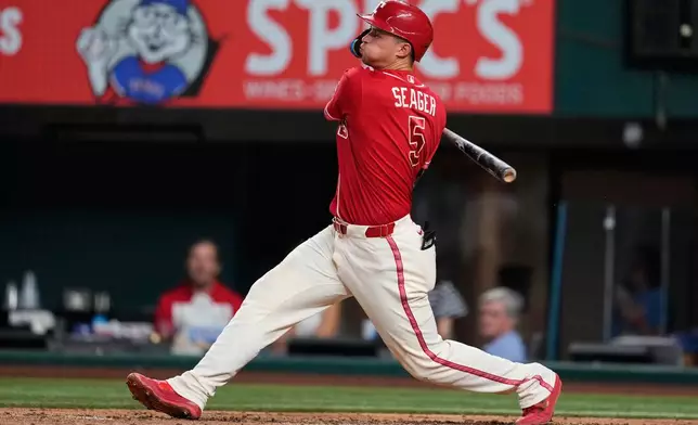 Texas Rangers' Corey Seager follows through on a single during the sixth inning of a baseball game against the Tampa Bay Rays Friday, Sept. 4, 2026, in Arlington, Texas. (AP Photo/Tony Gutierrez)