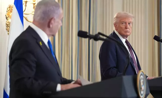 FILE - President Donald Trump, right, listens during a news conference with Israeli Prime Minister Benjamin Netanyahu in the State Dining Room of the White House, Sept. 29, 2025, in Washington. (AP Photo/Evan Vucci, File)