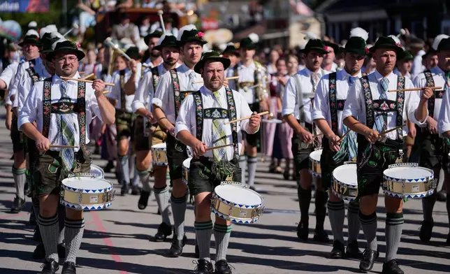 Musicians wear traditional costumes in the Oktoberfest parade at the 191st Oktoberfest beer festival in Munich, Germany, Saturday, Sept.19, 2026. (AP Photo/Matthias Schrader)