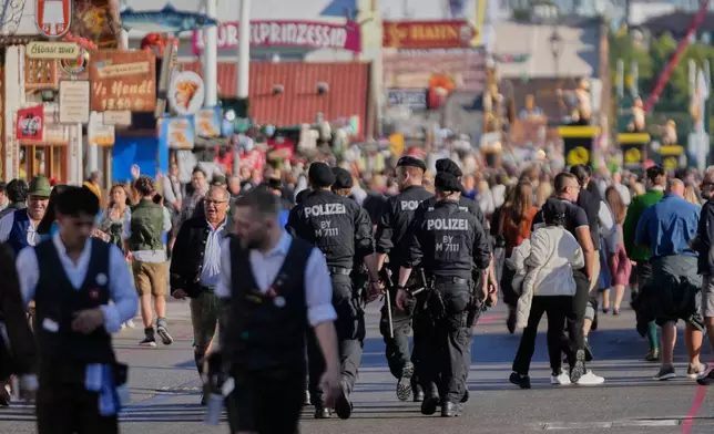 German police officers patrol at the 191st Oktoberfest beer festival in Munich, Germany, Saturday, Sept.19, 2026. (AP Photo/Matthias Schrader)