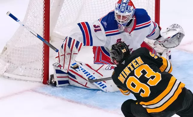 New York Rangers' Igor Shesterkin (31) makes a save on a shot by Boston Bruins' Fraser Minten (93) during the second period of an NHL hockey game, Tuesday, Sept. 29, 2026, in Boston. (AP Photo/Charles Krupa)