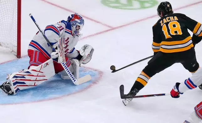 New York Rangers' Igor Shesterkin (31) drops to make a save on a shot by Boston Bruins' Pavel Zacha (18) during the second period of an NHL hockey game, Tuesday, Sept. 29, 2026, in Boston. (AP Photo/Charles Krupa)