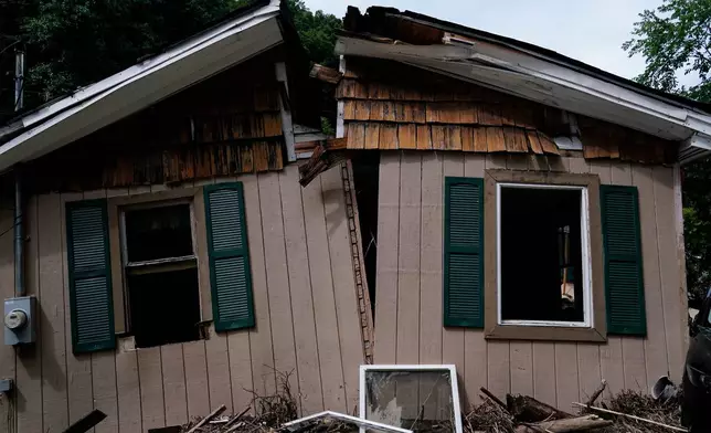 FILE - Nellie Mae Howard's home was split in half as it was swept away by recent massive flooding in Chavies, Ky., Aug. 4, 2022. Howard was killed in the flooding. (AP Photo/Brynn Anderson, File)