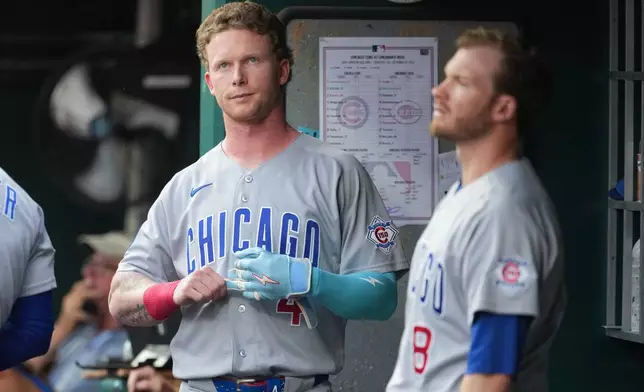 Chicago Cubs' Pete Crow-Armstrong, left, looks at the scoreboard during the first inning of a baseball game against the Cincinnati Reds, Friday, Sept. 18, 2026, in Cincinnati. (AP Photo/Kareem Elgazzar)