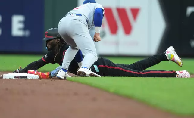 Cincinnati Reds' Elly De La Cruz, bottom, steals second base before Chicago Cubs second baseman Nico Hoerner, top, can apply a tag during the first inning of a baseball game Friday, Sept. 18, 2026, in Cincinnati. (AP Photo/Kareem Elgazzar)