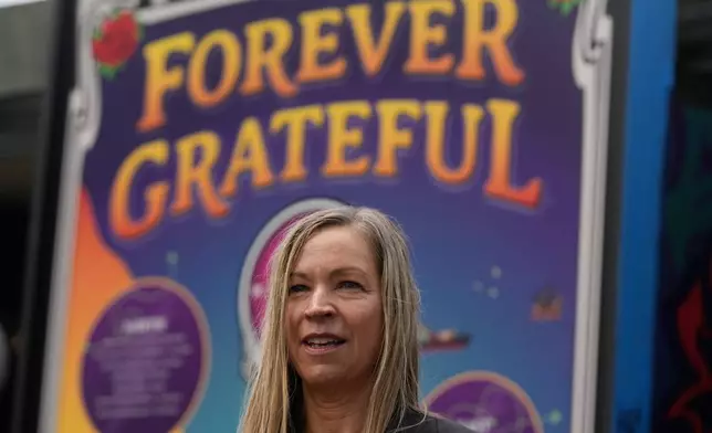 Kelly Harris, Executive Director at Haight Street Art Center, is interviewed at the Forever Grateful exhibit presented by the Haight Street Art Center at the County Fair Building in Golden Gate Park, Tuesday, Sept. 1, 2026, in San Francisco. (AP Photo/Jeff Chiu)