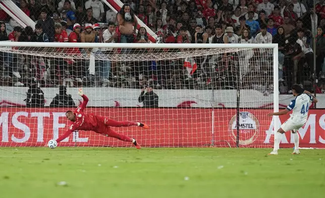 Goalkeeper Carlos Miguel of Brazil's Palmeiras saves a penalty by Luis Segovia of Ecuador's Liga Deportiva Universitaria in a shootout during a Copa Libertadores quarterfinal second leg soccer match in Quito, Ecuador, Wednesday, Sept. 16, 2026. (AP Photo/Dolores Ochoa)