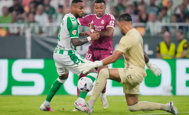 Betis' goalkeeper Alvaro Valles, right, blocks a shot by Real Madrid's Kylian Mbappe, center, during the Spanish La Liga soccer match between Real Betis and Real Madrid in Seville, Spain, Friday, Sept. 4, 2026. (AP Photo/Jose Breton)