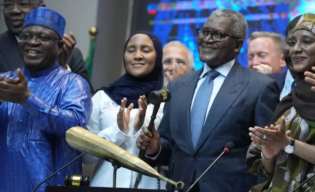 Nigerian industrialist Aliko Dangote, centre, participates in the Opening Gong Ceremony of the Dangote Refinery Initial Public Offer at the Nigeria Stock Exchange in Lagos Nigeria, Monday, Sept. 14, 2026. (AP Photo/Sunday Alamba)