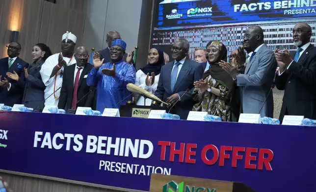 Nigerian industrialist Aliko Dangote, forth from Left, participates in the Opening Gong Ceremony of the Dangote Refinery Initial Public Offer at the Nigeria Stock Exchange in Lagos Nigeria, Monday, Sept. 14, 2026. (AP Photo/Sunday Alamba)