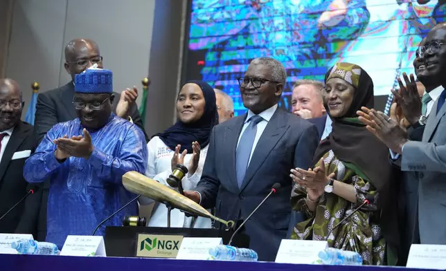 Nigerian industrialist Aliko Dangote, centre, participates in the Opening Gong Ceremony of the Dangote Refinery Initial Public Offer at the Nigeria Stock Exchange in Lagos Nigeria, Monday, Sept. 14, 2026. (AP Photo/Sunday Alamba)