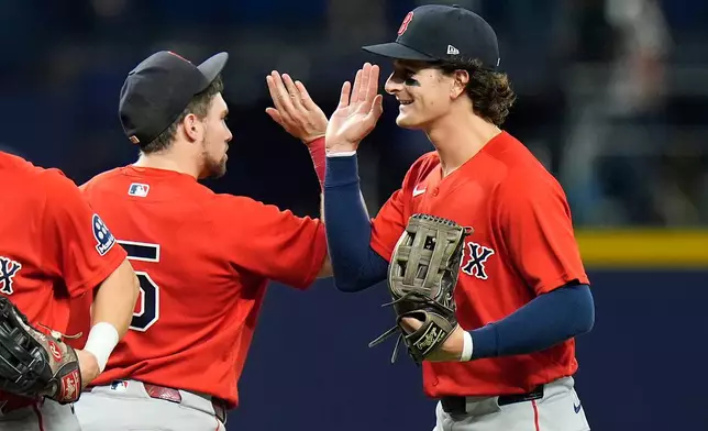 Boston Red Sox left fielder Roman Anthony celebrates with third baseman Caleb Durbin (5) after the team defeated the Tampa Bay Rays during a baseball game Friday, Sept. 18, 2026, in St. Petersburg, Fla. (AP Photo/Chris O'Meara)