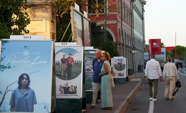 People view film posters prior to the 83rd edition of the Venice Film Festival in Venice, Italy, on Monday, Aug. 31, 2026. (Photo by Alessandra Tarantino/Invision/AP)