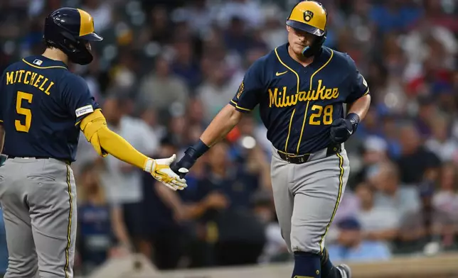 Milwaukee Brewers' Andrew Vaughn, right, celebrates with teammate Garrett Mitchell (5) after hitting solo home run during the fourth inning of a baseball game against the Chicago Cubs in Chicago, Thursday, Sept. 3, 2026. (AP Photo/Paul Beaty)