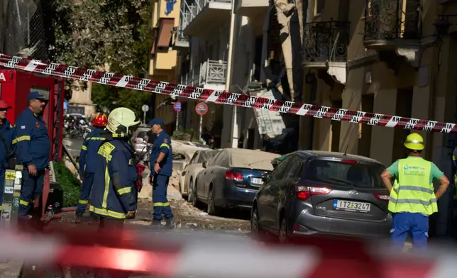 Firefighters work at the scene following a powerful blast that caused a building to collapse and injured at least two people in Athens' Plaka district, Friday, Sept. 25, 2026. (AP Photo/Petros Giannakouris)