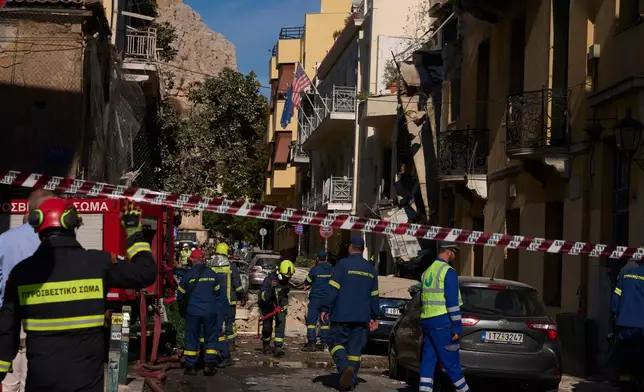 Firefighters work at the scene following a powerful blast that caused a building to collapse and injured at least two people in Athens' Plaka district, Friday, Sept. 25, 2026. (AP Photo/Petros Giannakouris)