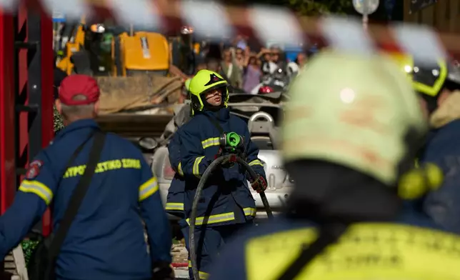 Firefighters work at the scene following a powerful blast that caused a building to collapse and injured at least two people in Athens' Plaka district, Friday, Sept. 25, 2026. (AP Photo/Petros Giannakouris)