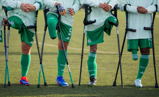 Maccabi Haifa's players line up before an amputee soccer match between Maccabi Haifa and Panathinaikos in the inaugural EAFF Conference League in Bucharest, Romania, Thursday, Sept. 24, 2026. (AP Photo/Andreea Alexandru)