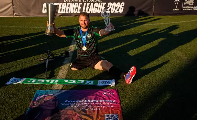 Maccabi Haifa's Ben Binyamin poses with the trophy during the medal ceremony at the end of the amputee soccer inaugural EAFF Conference League in Bucharest, Romania, Friday, Sept. 25, 2026. (AP Photo/Andreea Alexandru)
