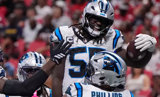 Carolina Panthers linebacker Devin Lloyd (55) celebrates touchdown after an interception during an NFL football game against the Atlanta Falcons in Atlanta, Sunday, Sept. 20, 2026. (AP Photo/Mike Stewart)