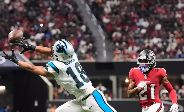 Carolina Panthers wide receiver Jalen Coker (18) makes a catch against Atlanta Falcons cornerback Mike Hughes (21) during an NFL football game in Atlanta, Sunday, Sept. 20, 2026. (AP Photo/Mike Stewart)