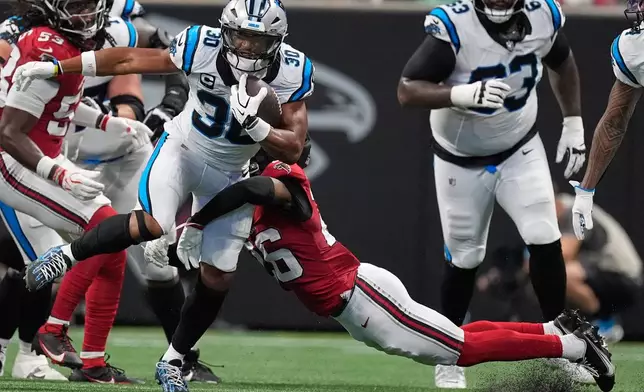 Carolina Panthers running back Chuba Hubbard (30) runs against Atlanta Falcons defensive tackle Gervon Dexter Sr. (95) during an NFL football game in Atlanta, Sunday, Sept. 20, 2026. (AP Photo/Mike Stewart)